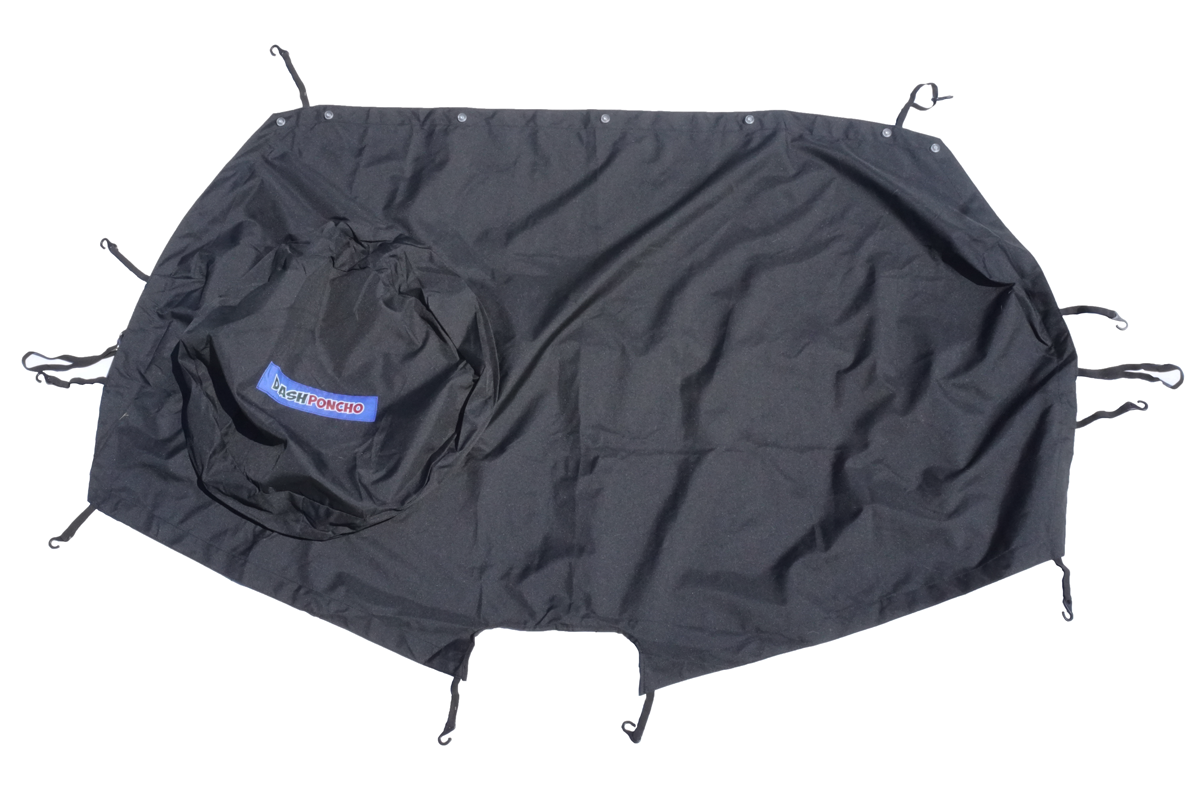 A black Dash Poncho brand dashboard cover with bungee cords and suction cups designed to protect the dashboard of a Jeep Wrangler JL/JLU or Gladiator JT  from rain, sun, dust, wind, and sand.